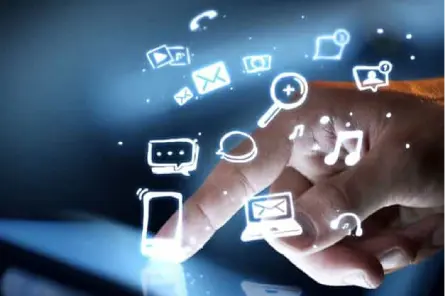 A hand touching a tablet displaying various icons.